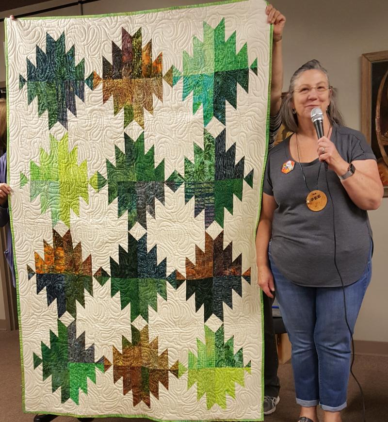 Peg shows a birthday quilt made by Connie 