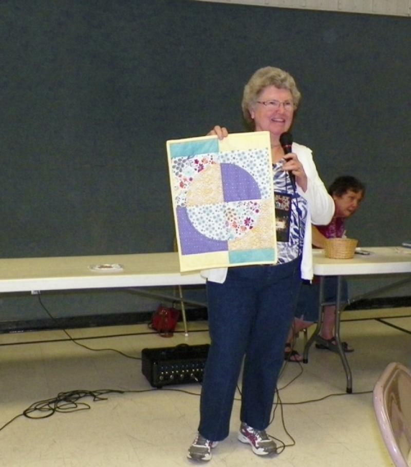 Connie Mc shows a placemat from Vickie W's class.