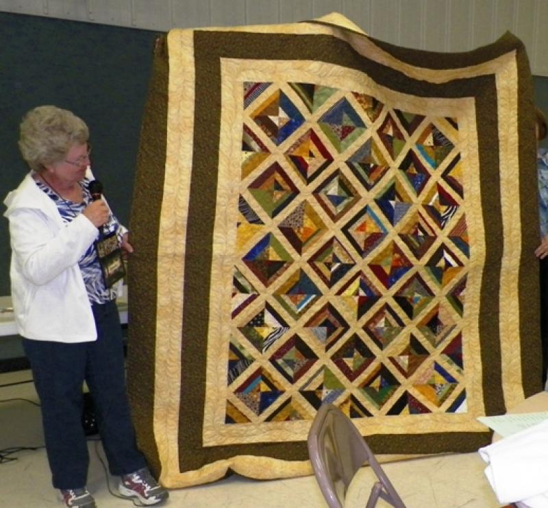 Connie Mc shows a strip quilt