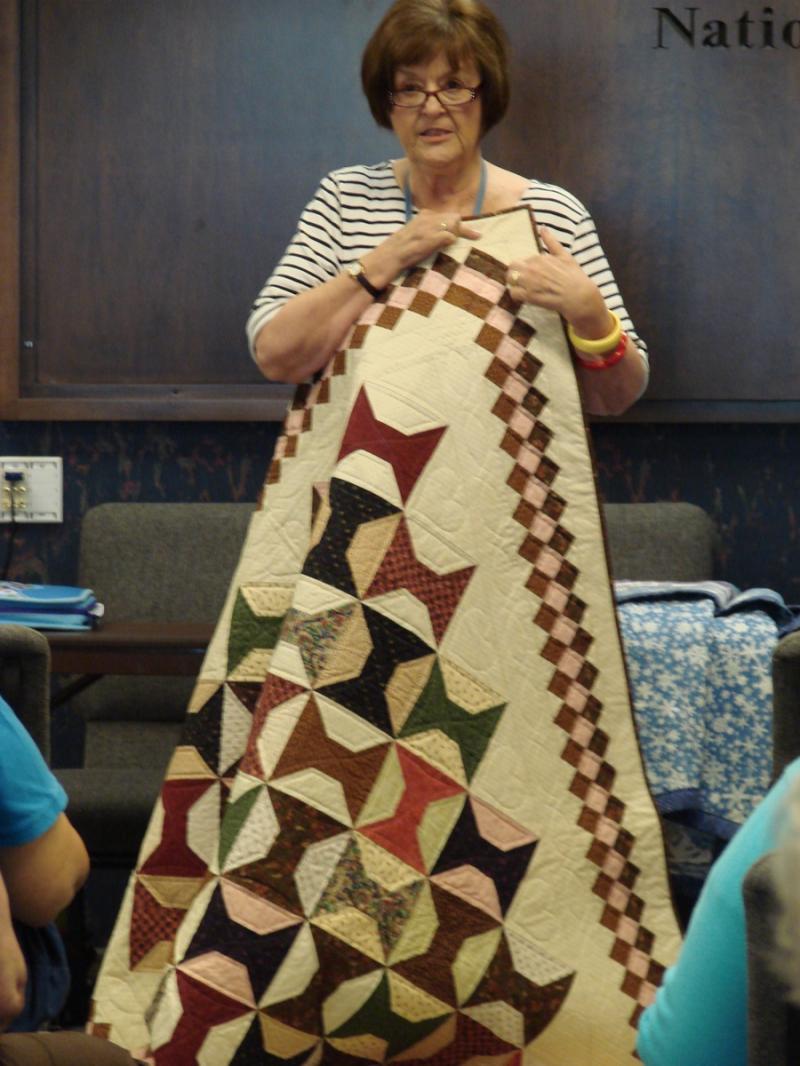 Elaine Moore with sample of February Class~Scrappy Spools with diagonally set border