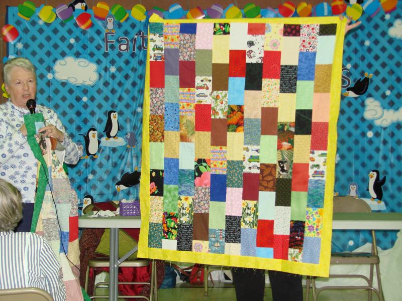 Tina with scrappy Linus Quilt