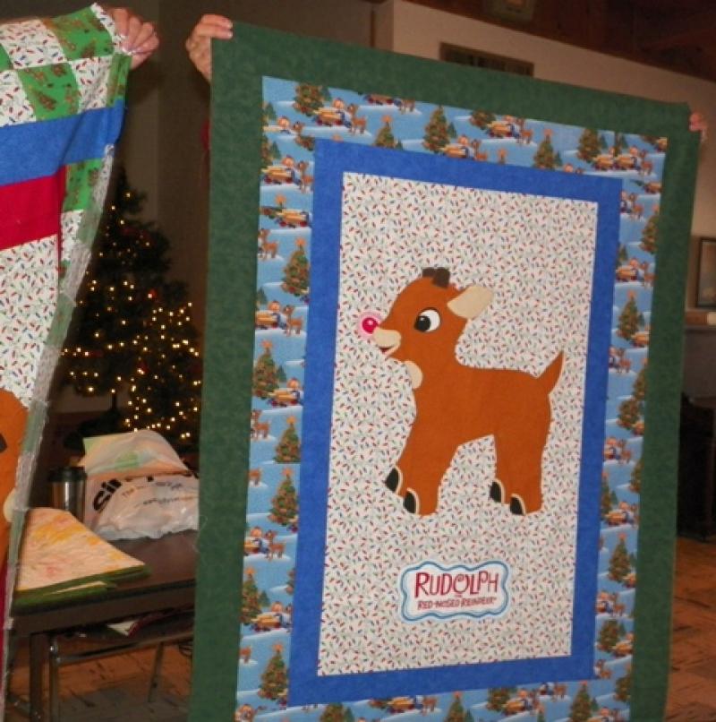 Deb M. shows aRudolph the Red-Nosed reindeer quilt.
