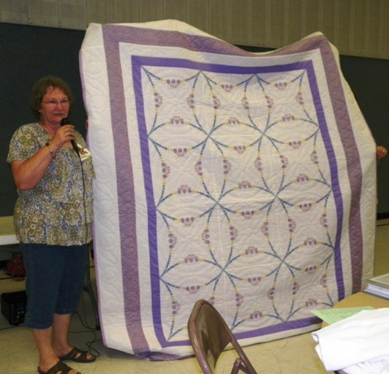 An embroidered quilt made by Diane C's mother.