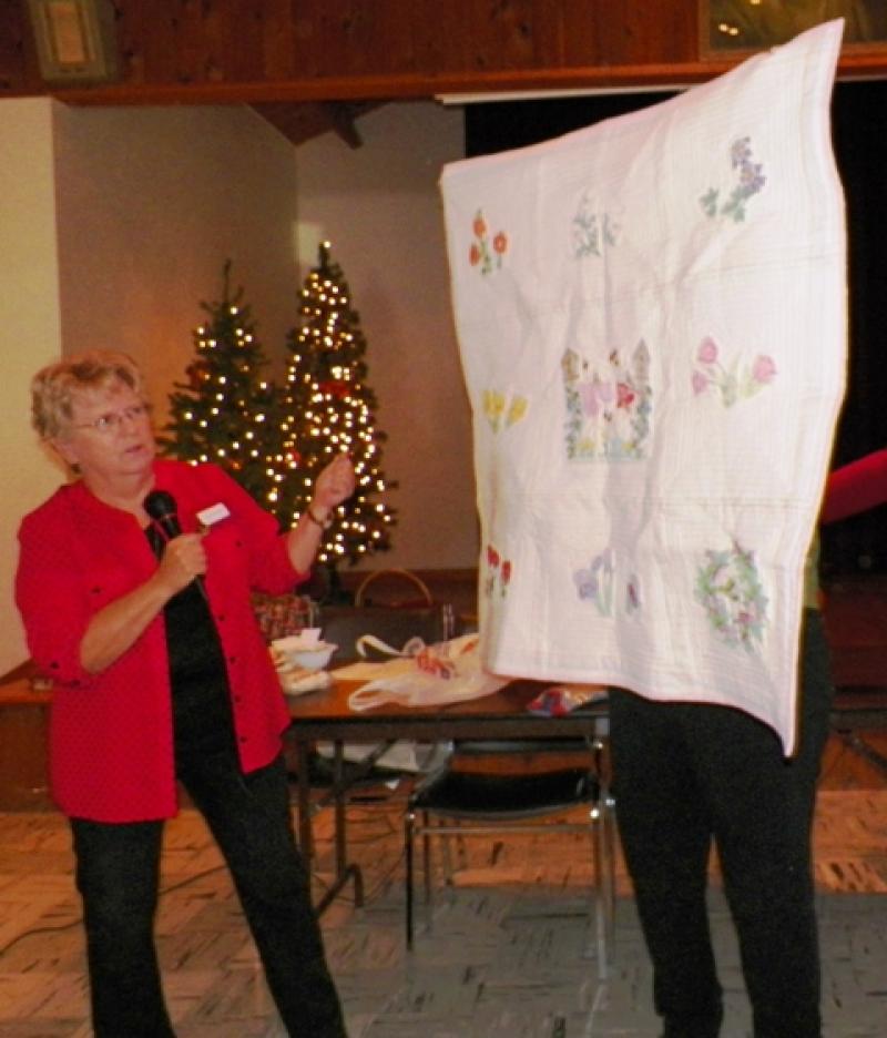 Donna R show an embroidered quilt.