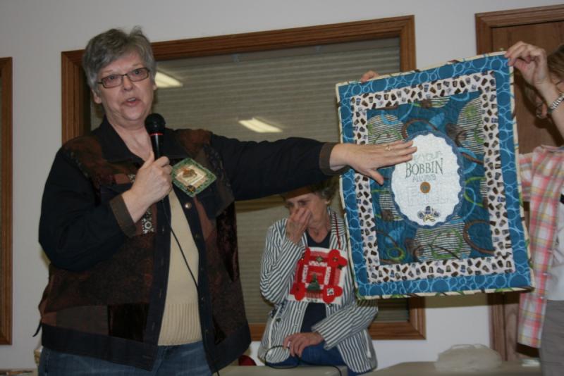 Sandy with Embroidered wall hanging from Women's Retreat/she handmade the lace and buttons