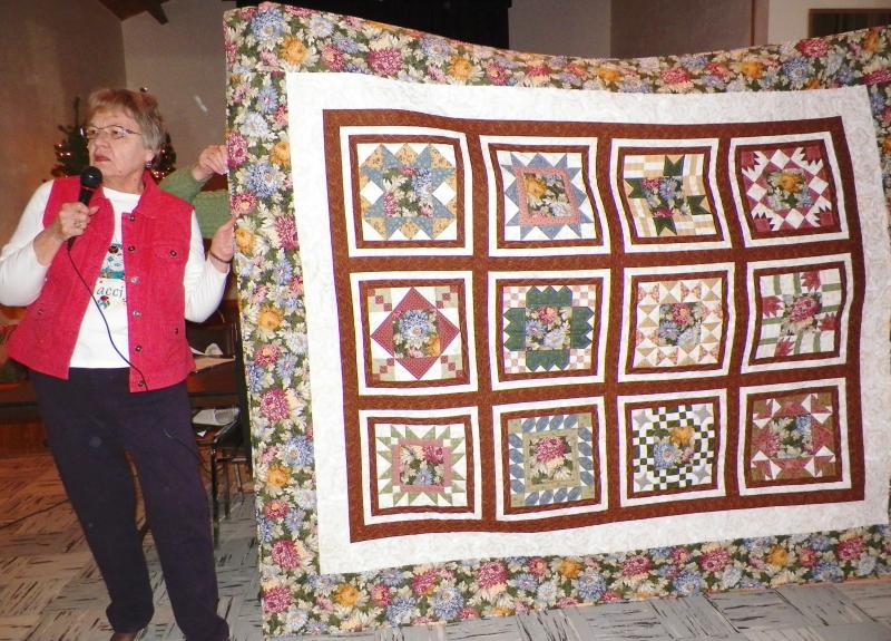 Jacci I show raffle quilt, funds to be donated to a cancer patient.
