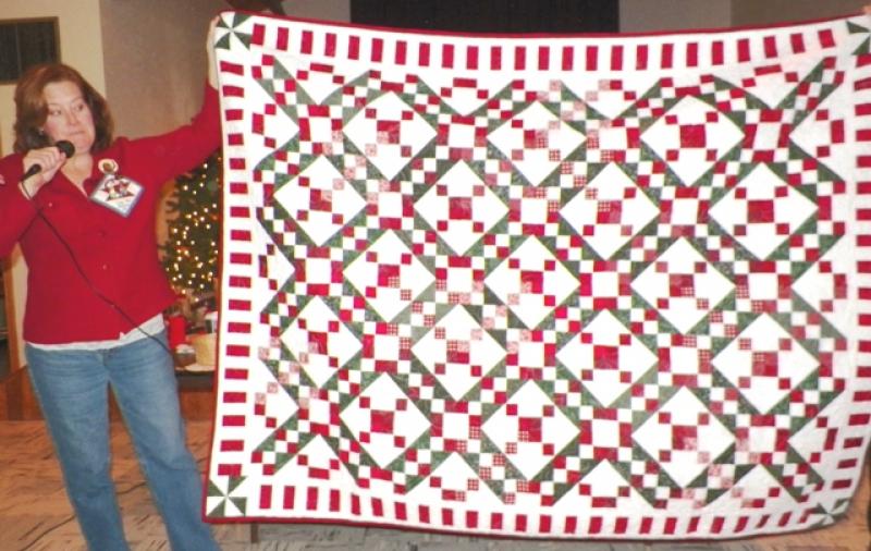 Jody M shows quilt made from won BOM blocks 2011.