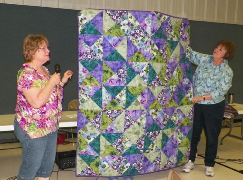 Kathy Mc shows a Pansy flannel throw.