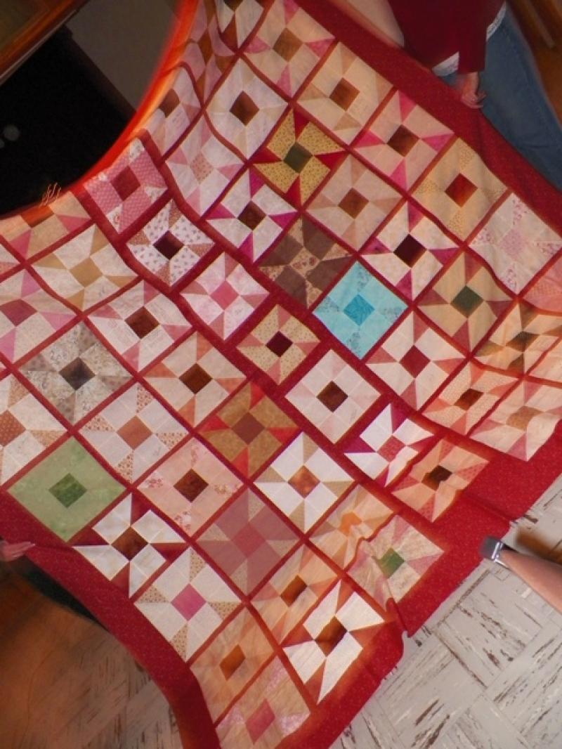 Sharon C. shows her President's Block quilt top, 2011.
