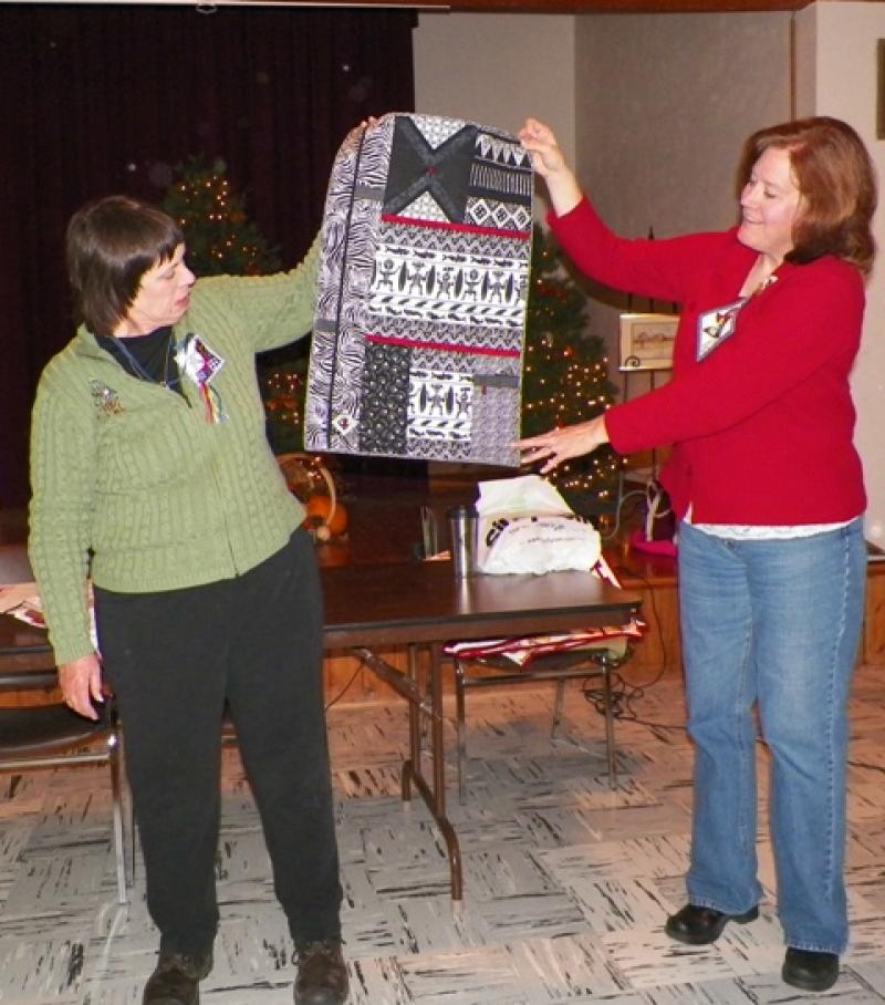 Sharon C. shows a small quilt done in black and white with red accents. 