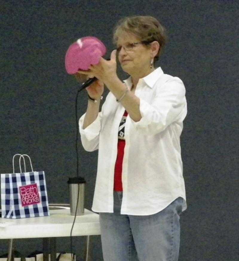 Sharon C shows a cupcake pot holder for Silent Auction.